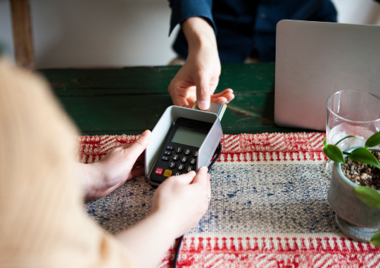 和紙上の木製トレイで行われるスマートフォンやカードによるキャッシュレス決済